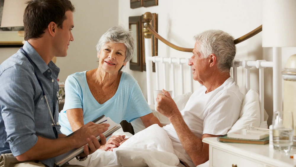 A man and woman talking to an older couple.