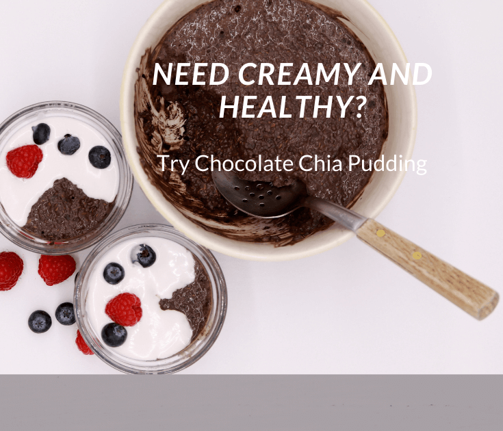 A bowl of chocolate pudding with berries and whipped cream.